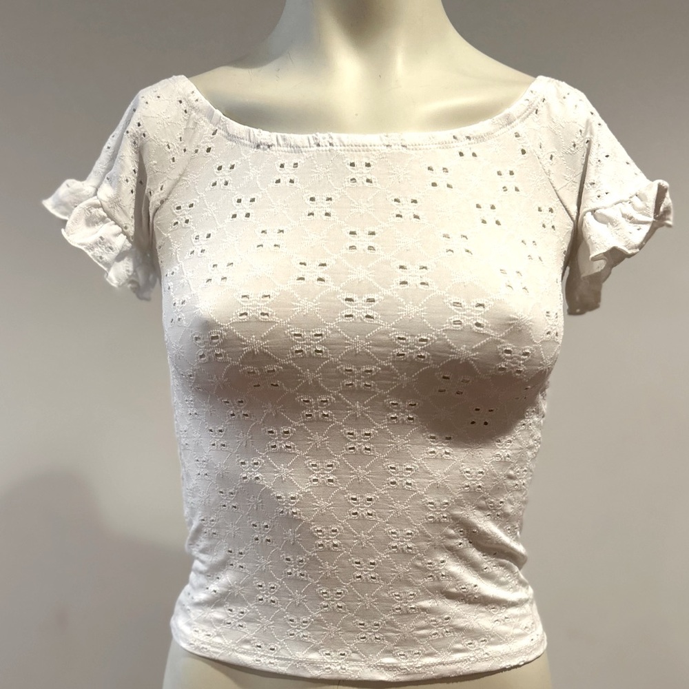 White crop top with slightly ruffled sleeve, scooped neckline.  Gently worn